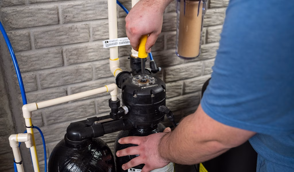 person servicing a water softener