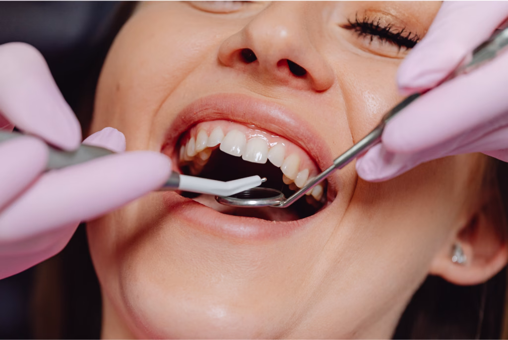 Woman receiving a dental exam from a dentist in a clinical setting