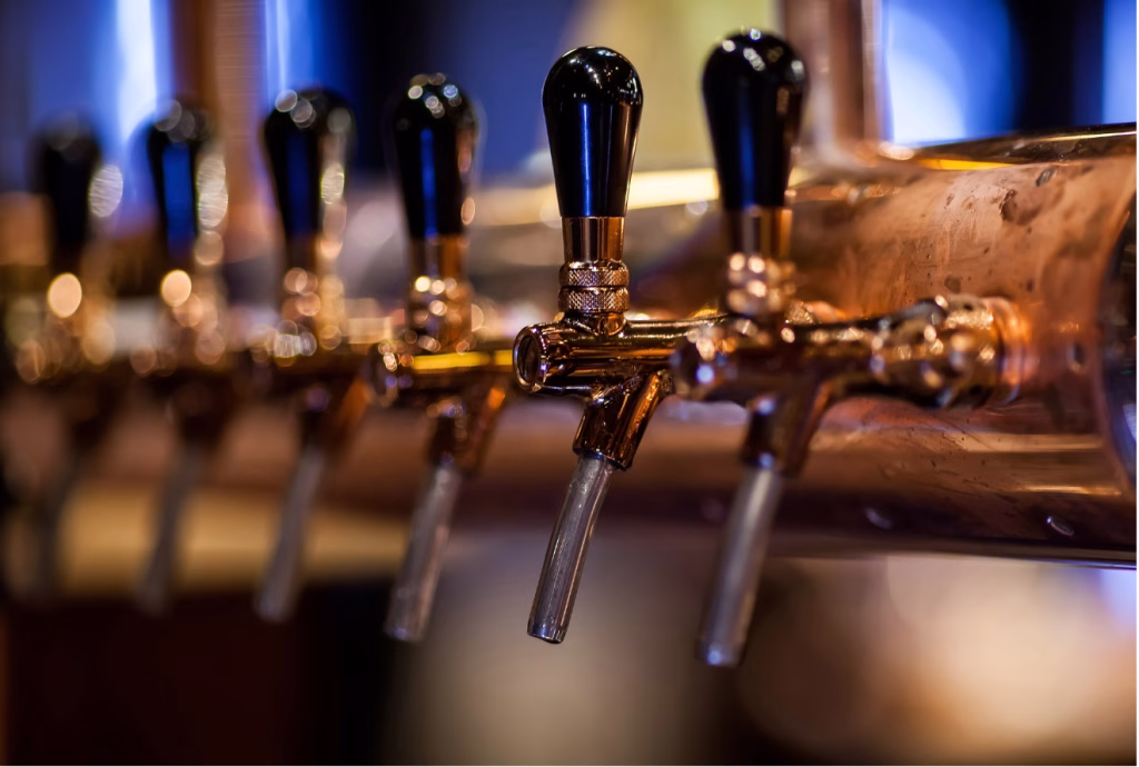 Row of beer taps at a brewery bar